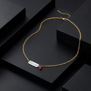Gold-tone metal letter Queen pendant necklace featuring a delicate red heart charm detail.