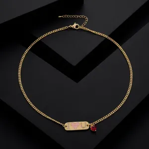 Gold-plated copper necklace featuring a crystal letter tag and a red heart pendant for women.