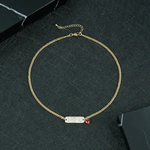 Detail view of copper zircon letter necklace with red heart pendant, stylish clavicle chain.