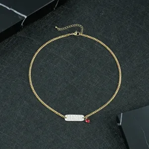 Gold tone copper necklace featuring a MAMA crystal plaque pendant and a lovely red heart charm for women.