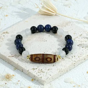Tibetan style multi-color gemstone beaded bracelet detail, vintage Dzi bead jewelry close up.