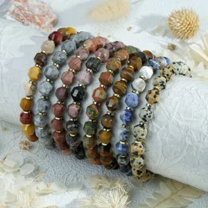 Close-up detail of vintage multi-color faceted gemstone beaded bracelets layered stack display.