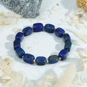 Close-up detail of the irregular block lapis lazuli gemstone bracelet with gold spacers.