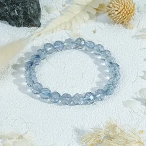 Detail view of a translucent blue faceted crystal beaded bracelet, elegant and gentle.