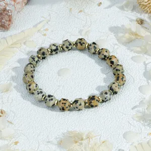 Detail view of vintage dalmatian jasper gemstone bracelet with shiny gold metal spacer beads