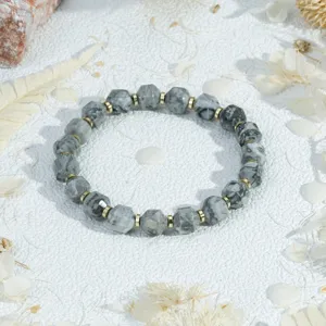 Detailed view of a faceted gemstone beaded bracelet with gold spacers for women jewelry.