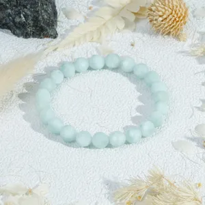 Detailed close-up of a light blue faceted crystal bead bracelet, elegant jewelry accessory.