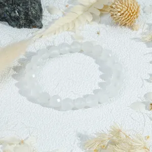 Close-up of the clear faceted crystal bead bracelet, showing delicate cutting details and texture.