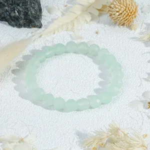Clear light green crystal bead bracelet detail, elegant faceted gemstone jewelry for women.
