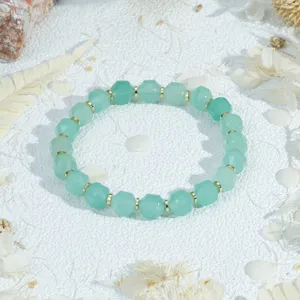 Vintage green faceted stone beaded bracelet with gold spacers, elegant stackable jewelry design.