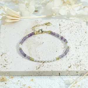 Exquisite detail view of handmade beaded bracelet featuring purple crystal and elegant faux pearls.