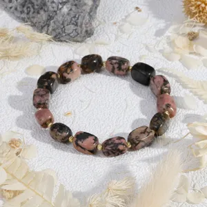Close-up detail shot of irregular stone beaded bracelet with delicate gold-tone spacers.