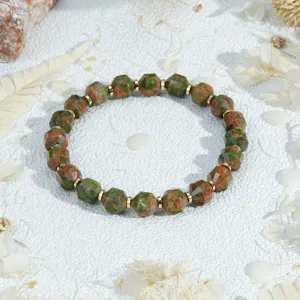 Charming unakite gemstone beaded bracelet with chic gold spacers, vintage style stacked hand jewelry.