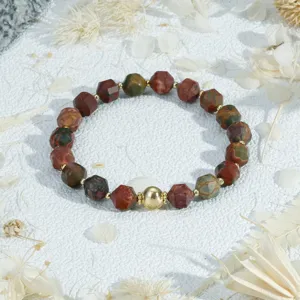 Detailed close-up of vintage multi-color faceted stone bead bracelet with gold accents.