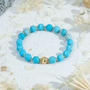 Faceted blue stone bead bracelet with a central gold metallic ball for women daily wear.
