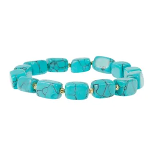 Close-up view of a chic turquoise block bead bracelet featuring polished gold spacer accents.