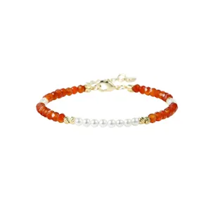 Faceted orange carnelian and white pearl beaded bracelet with gold spacers detail shot