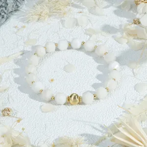 Exquisite white faceted bead bracelet with golden accent beads for elegant daily wear.