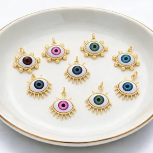 Close up detail of colorful resin evil eye pendants, gold plated DIY jewelry charms.
