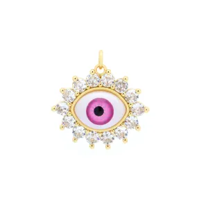 Detailed shot of evil eye pendant with pink resin center and sparkling cubic zirconia.