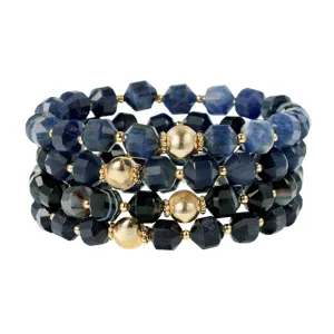Detailed view of multi-layer faceted gemstone bracelet stack with blue and gold beads.