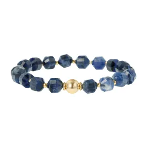 Close-up detail of faceted blue gemstone bead bracelet with central gold textured charm.