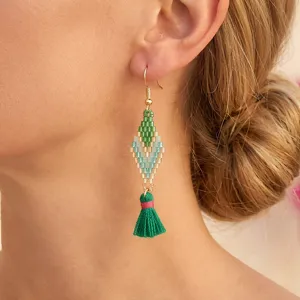 Detail view of handmade bohemian beaded tassel earrings featuring colorful geometric diamonds.