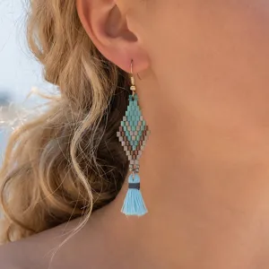 Bohemian beaded tassel earrings detail shot featuring handmade diamond shaped turquoise and blue design.