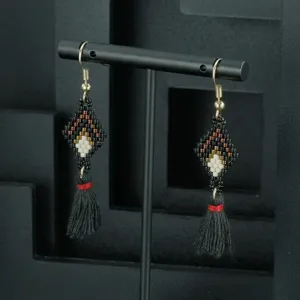 Handcrafted beaded tassel earrings featuring geometric diamond patterns and black fringe dangles.