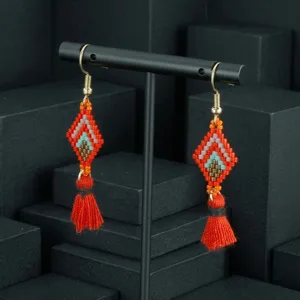 Boho beaded tassel earrings featuring colorful geometric diamond design and vibrant orange tassels.