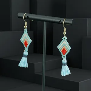 Handmade seed bead diamond tassel earrings detail shot, bohemian style blue jewelry showcase.