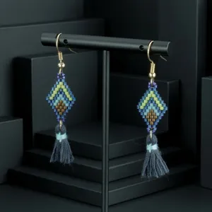 Bohemian seed bead tassel earrings detail, handmade geometric diamond design, resort jewelry close-up.