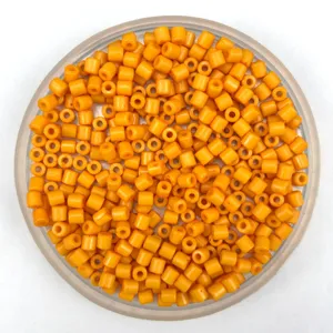 Close-up of vibrant orange acrylic cylinder craft beads, perfect for DIY jewelry making.