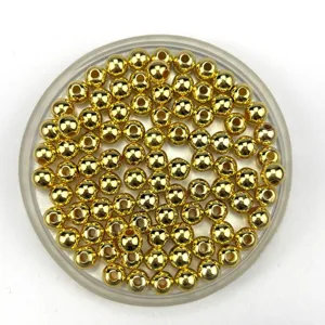 Close-up of shiny gold round beads in a clear container, perfect for DIY jewelry crafting.