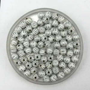 Close-up detail of white acrylic pumpkin beads with silver lines, perfect for DIY jewelry making.
