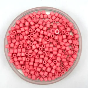 Close-up view of pink acrylic barrel beads in a dish, perfect details for DIY jewelry making.