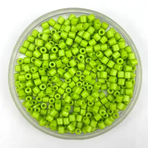 Close-up detail of bright green acrylic barrel beads for DIY bracelets and necklaces crafting.