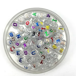 Close-up of clear acrylic alphabet beads with colorful letters for DIY jewelry making accessories.
