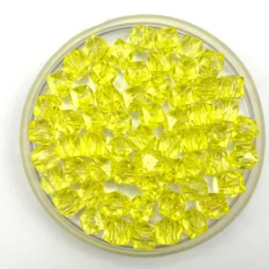 Detail shot of yellow transparent square faceted acrylic loose beads for DIY handmade jewelry craft.