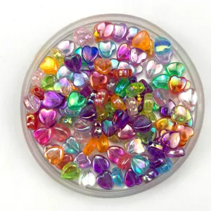 Colorful transparent iridescent heart shaped acrylic beads for DIY jewelry making crafts projects.