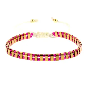 Boheemse handgemaakte gewoven kralenarmband met metalen staven en roze kralen.