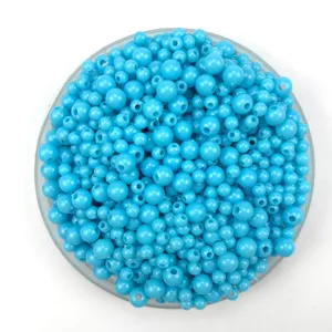 Close-up detail of bulk blue acrylic plastic loose craft beads for DIY jewelry making bracelets.