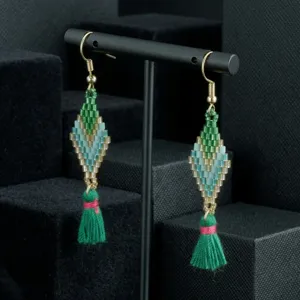 Handmade beaded tassel earrings detail shot featuring green rhombus design and delicate gold hooks.