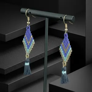 Handmade bohemian seed bead tassel earrings with diamond shape design for vacation.