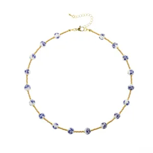 Details of the Chinese style blue and white porcelain ceramic bead gold chain necklace.