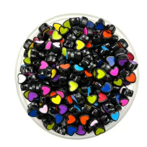 Close-up of black acrylic heart beads with colorful centers, perfect for DIY jewelry and phone charms.
