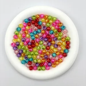Close-up detail shot of colorful transparent acrylic globe beads mixed for DIY jewelry crafts.