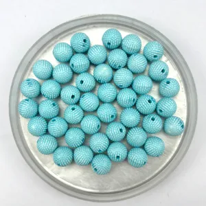 Close up detail of blue acrylic dotted round beads for DIY jewelry making and craft projects.