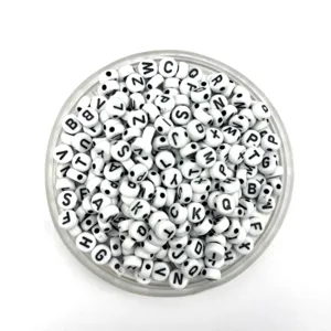 Detailed view of white acrylic alphabet beads in a transparent container for DIY crafts.