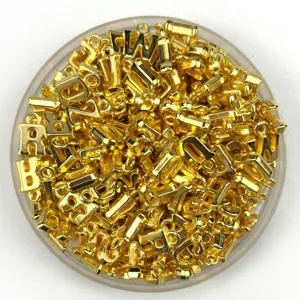 Gold metal alphabet letter charms closeup, bulk DIY jewelry making beading pendant accessories.